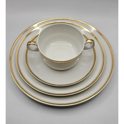 White cup with gold trim and matching saucer
