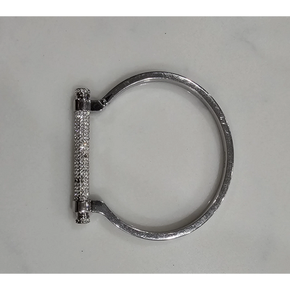 Silver bracelet with a clasp on a gray background