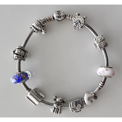 Silver charm bracelet with various charms 