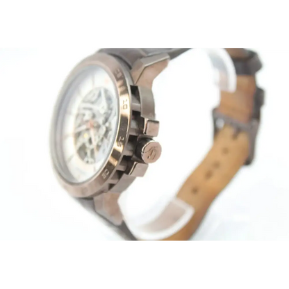 Close-up of a wristwatch with a brown leather strap 