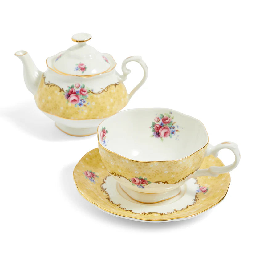 Tea set with teapot, cup, and saucer featuring floral designs on a white background