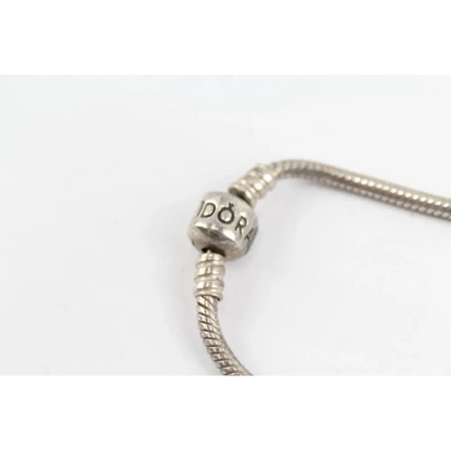 Silver bracelet with a close-up of a bead displaying 'DOR' 