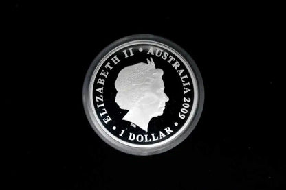 A silver 2009 Australian 1 Dollar coin featuring the profile of Queen Elizabeth II, encased in a protective plastic holder against a solid black background.
