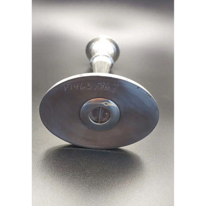 Metallic valve handle with visible serial number 
