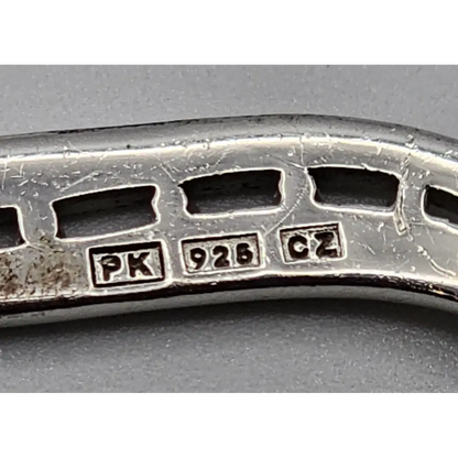 Close-up of a silver ring with visible hallmarks