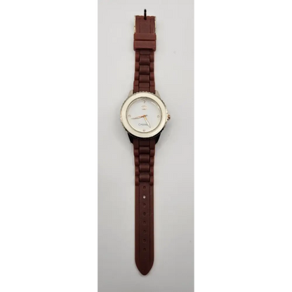 Watch with a brown strap on a light gray background