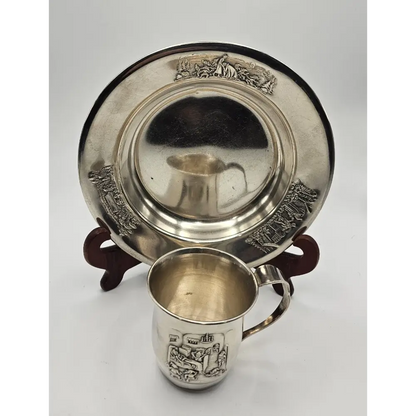 Silver cup and tray with engraved designs on a white background