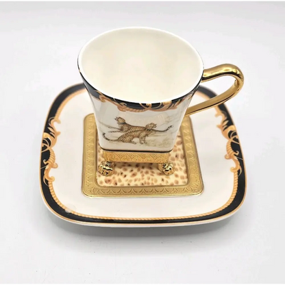 Decorative cup and saucer set with gold accents 