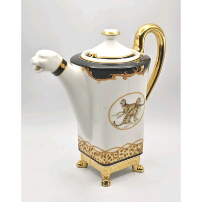 Decorative teapot with gold accents and animal illustrations