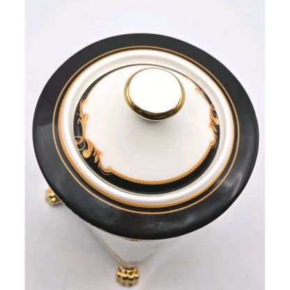 Decorative urn with black, gold, and white design
