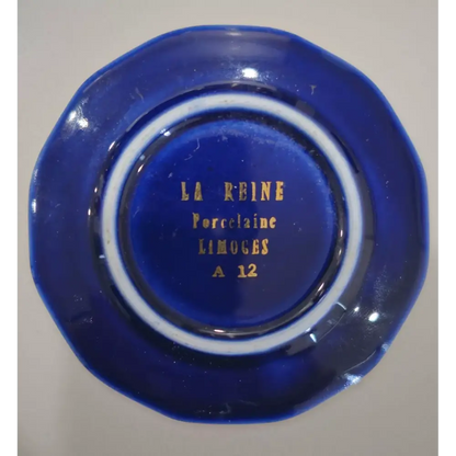 Blue ceramic dish with 'La Reine Porcelaine Limoges' branding
