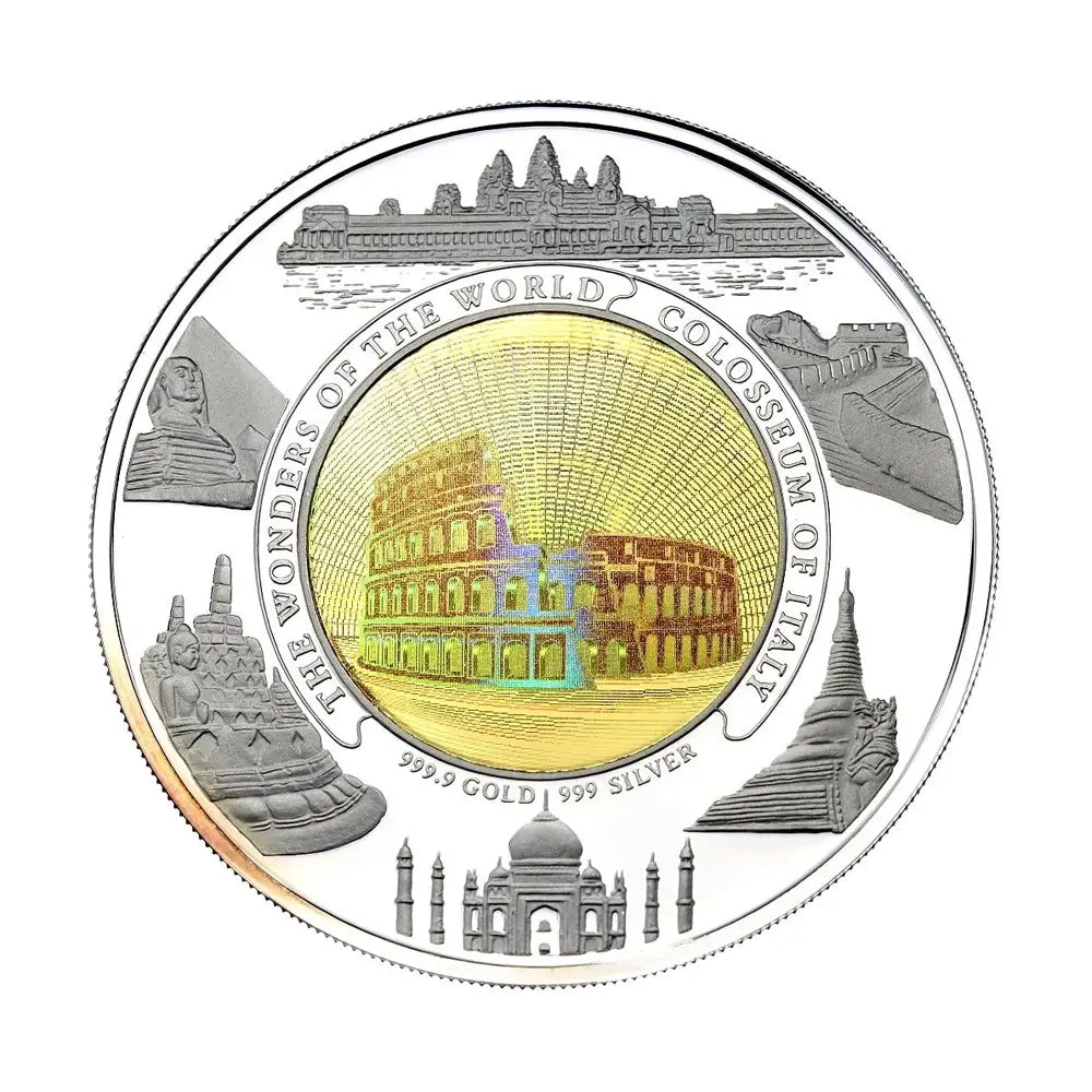 A round commemorative coin featuring the Seven Wonders of the World, with a gold-toned central colosseum design and silver-toned surrounding landmarks including the Sphinx, Great Wall, Taj Mahal, and St. Benedict's Monastery.