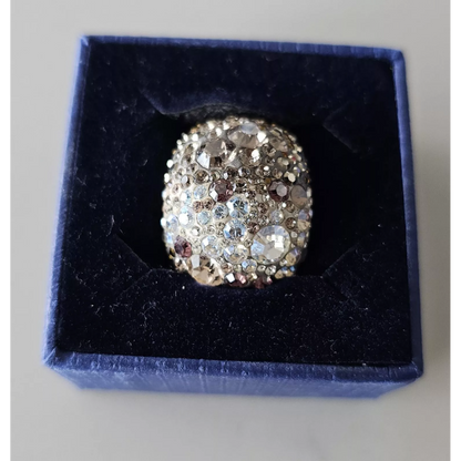 Silver ring with gemstones in a blue velvet box
