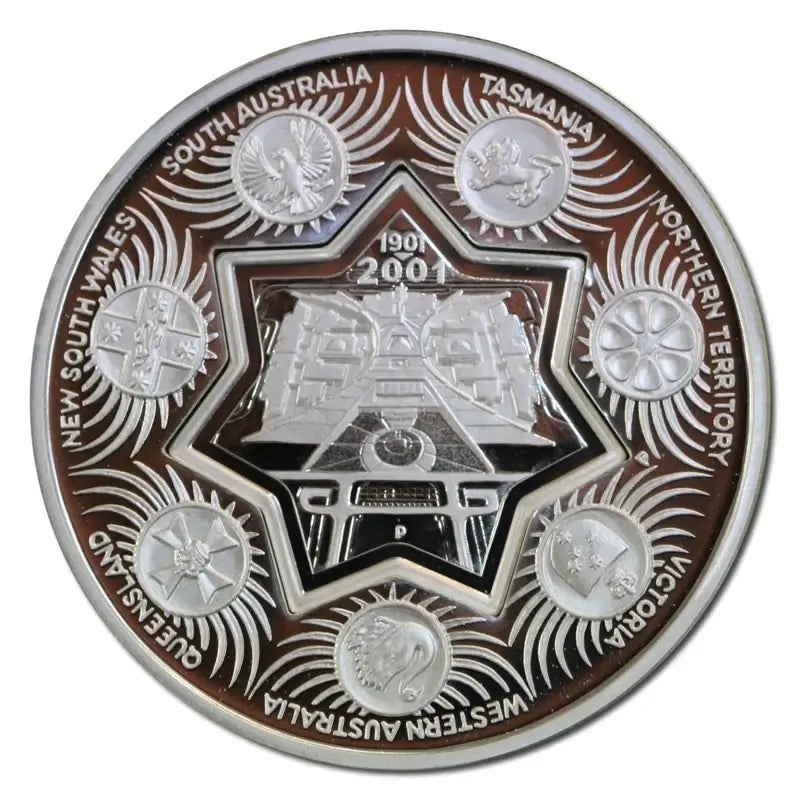 A circular commemorative coin featuring a silver-toned central star and train motif, surrounded by raised silver states and engraved text naming Australian regions including South Australia, Tasmania, Northern Territory, Queensland, Western Australia, Victoria, New South Wales, and South Australia. The outer ring is dark brown with silver detailing.