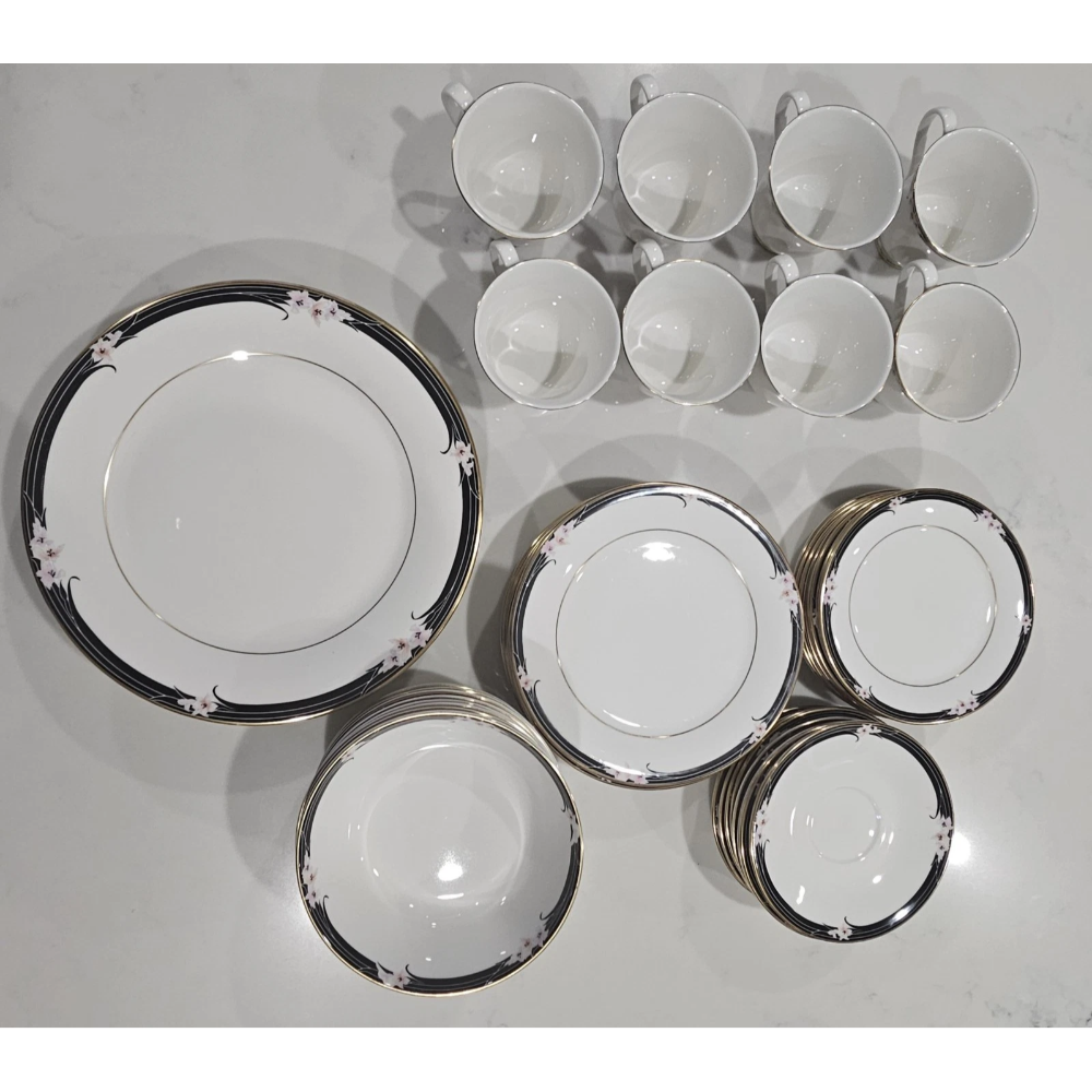 Set of ceramic dinnerware with decorative rim on a white surface