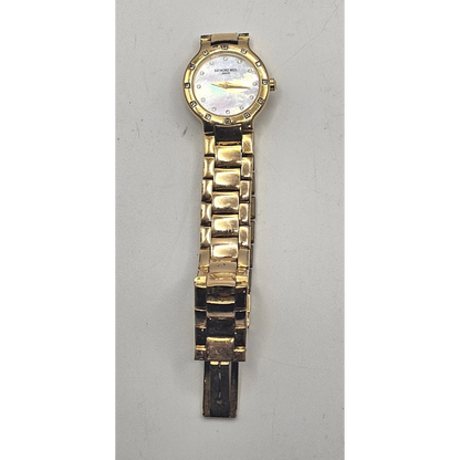 Gold watch on a light gray background