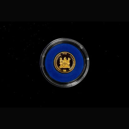 A round collectible coin or medallion featuring the gold seal of the Republic of the Congo, set against a vibrant blue background and enclosed in a clear protective capsule, shown on a black background from our World & Vintage Coins, Gold Proof Sets & Commemorative Medals collection 