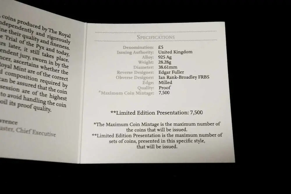 An open booklet or card showing printed specifications and text on a dark background.