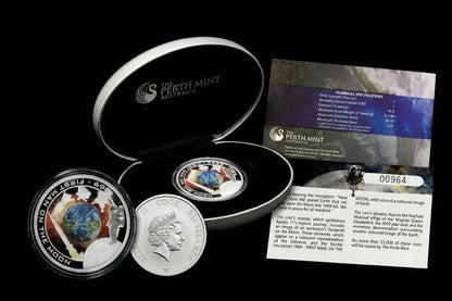 A 2023 Australia National Treasure Set from the Perth Mint, featuring a silver coin with Queen Elizabeth II's profile, a circular medallion with a globe design, an open silver presentation box, and informational cards from our World & Vintage Coinscollection