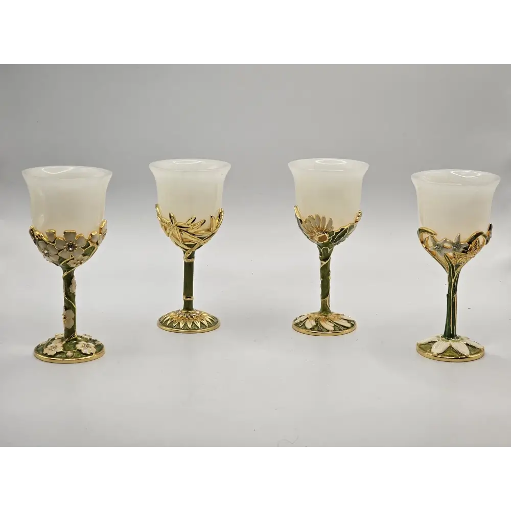 Four decorative glass goblets with gold accents