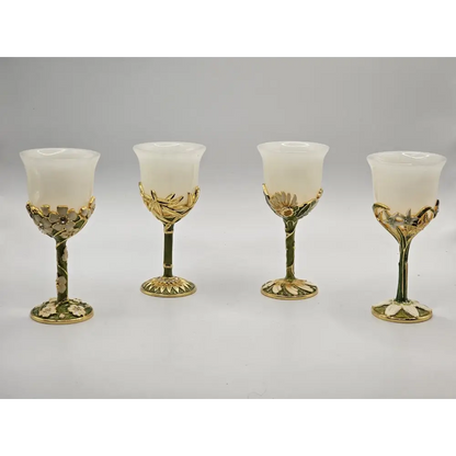 Four decorative glass goblets with gold accents