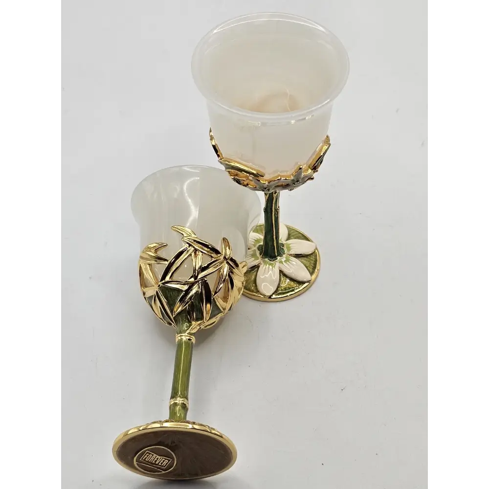 Two white goblets with gold bases