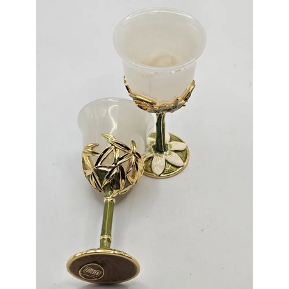 Two white goblets with gold bases