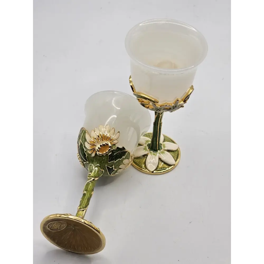 Two decorative glasses with floral designs on a white background