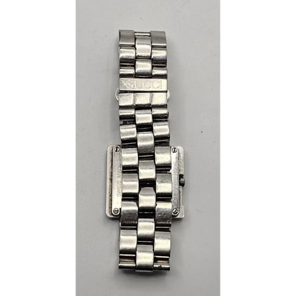 Silver watch band on a gray background