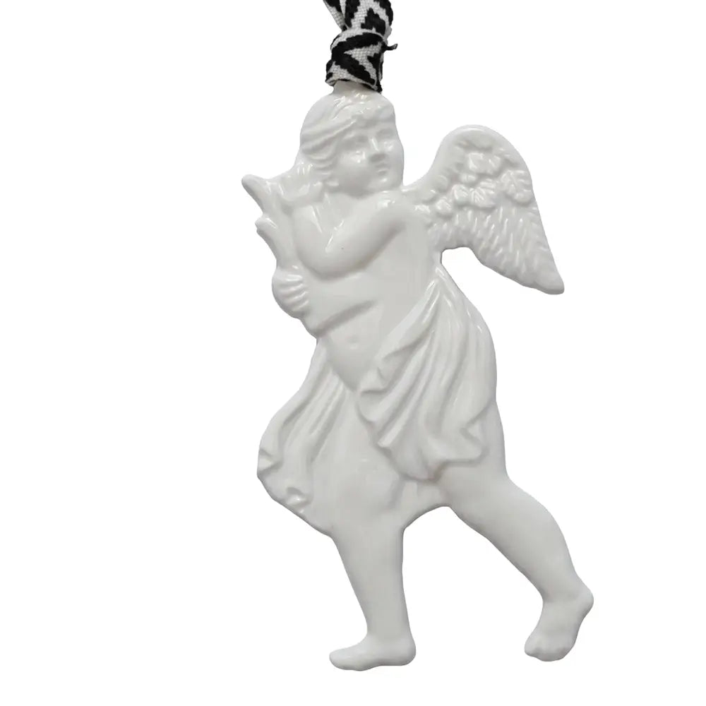 White ceramic angel ornament with a black and white patterned ribbon on a white background