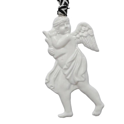 White ceramic angel ornament with a black and white patterned ribbon on a white background