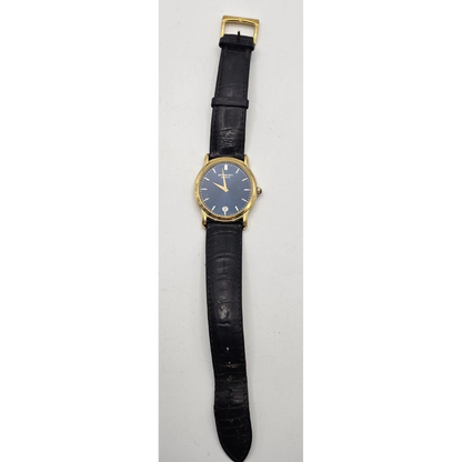 Wristwatch with black strap and gold case
