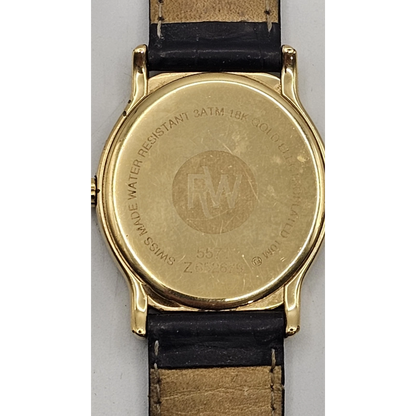 Gold watch with black leather strap on a white background