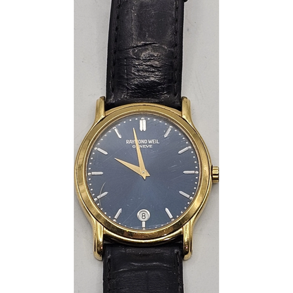 Raymond Weil watch with black face and gold case on a white background