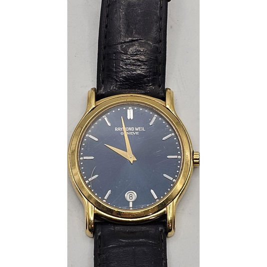Raymond Weil watch with black face and gold case on a white background