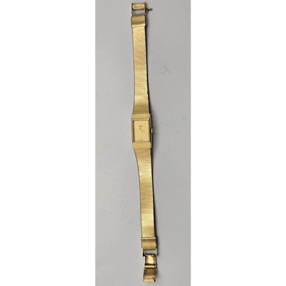 Gold watch strap on a gray background