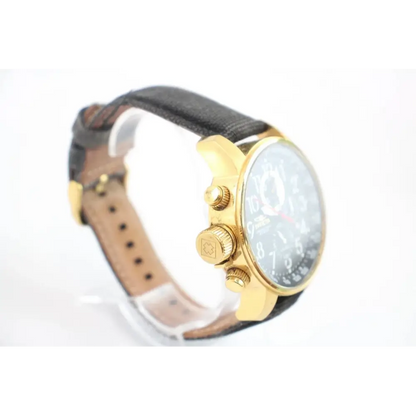 Watch with gold case and black leather strap