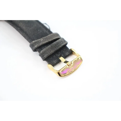 Gray watch strap with gold buckle on a white background