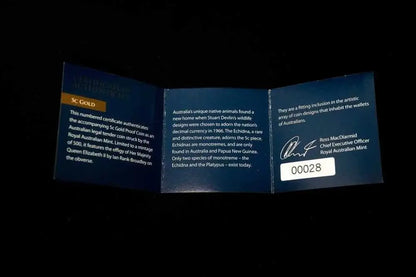 A folded blue certificate insert for an Australian gold coin, displayed against a black background. The left panel is labeled 'AUSTRALIAN GOLD COIN AUTHENTICATION' and shows gold coin details.
