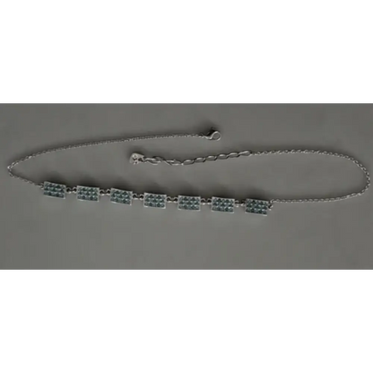 Necklace with green beads on a gray background