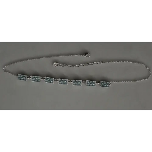 Necklace with green beads on a gray background