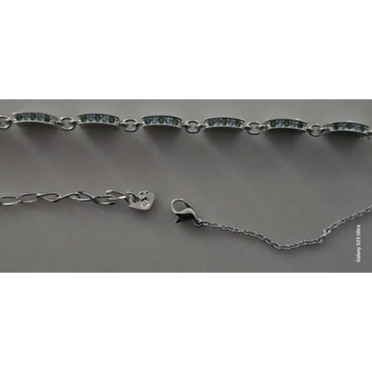 Silver bracelet with clasp on a gray background