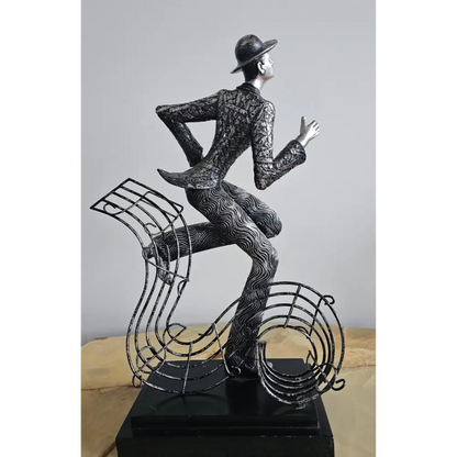 Decorative sculpture of a man sitting on a musical note
