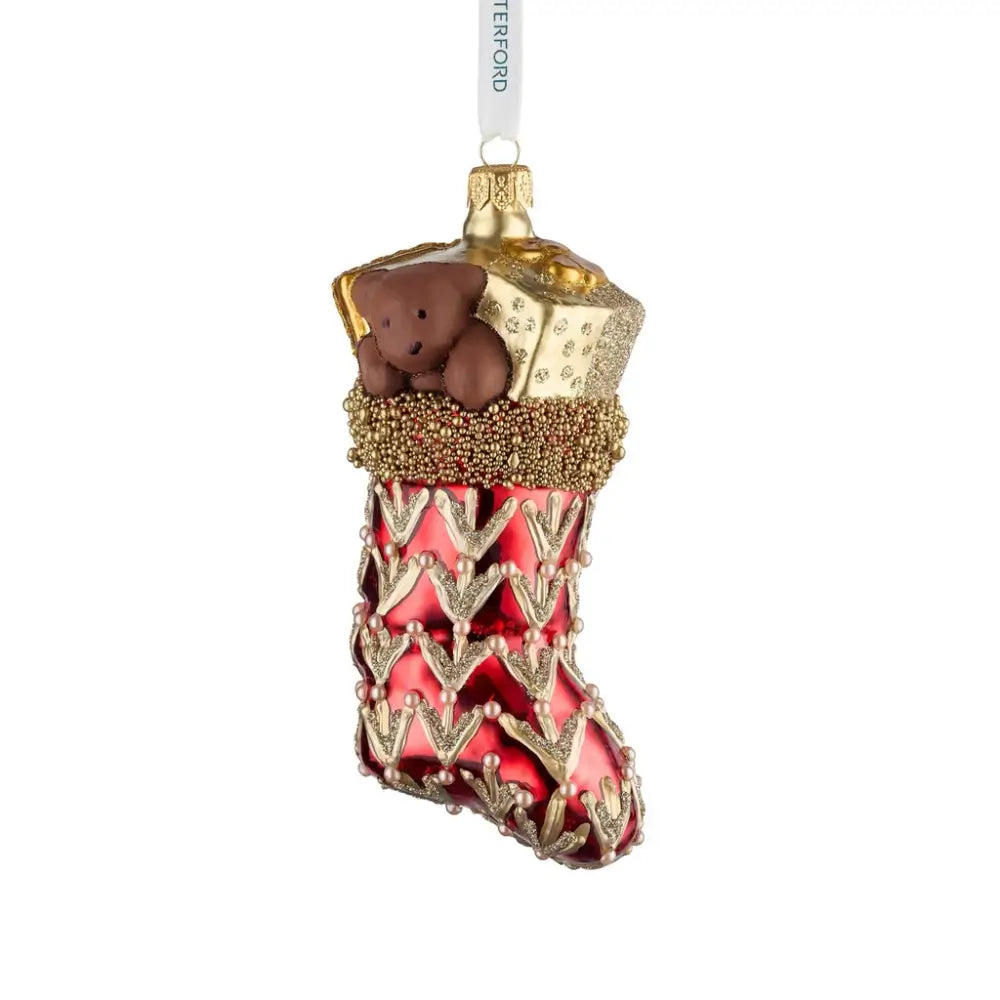 Decorative Christmas stocking ornament with a teddy bear and gold accents on a white background
