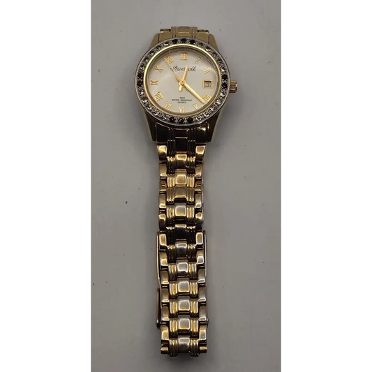 Gold wristwatch with a silver face