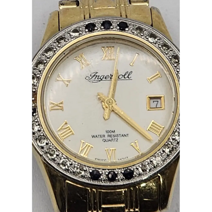 Gold wristwatch with diamond accents and Roman numeral markers 