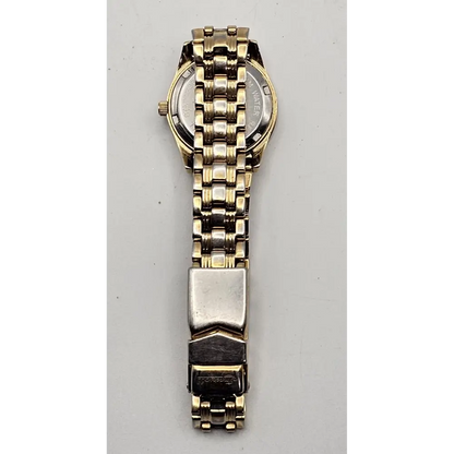 Gold and silver watch on a gray background