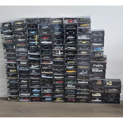 Stack of model car boxes on a plain background