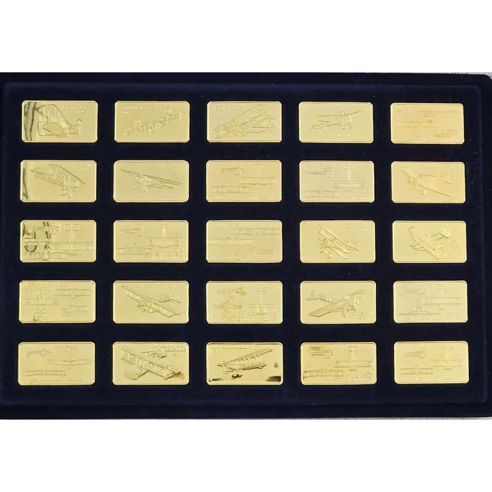 Set of gold bars with engraved designs on a black display case