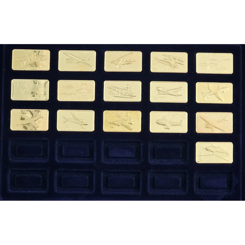 Collection of gold airplane-shaped chocolate bars in a black box